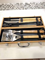 Open case showing all BBQ tools neatly strapped inside