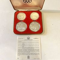Full set of four encapsulated coins in open presentation case