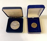 Both cased coins side by side