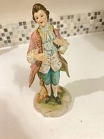 Front view of hand-painted porcelain male figurine
