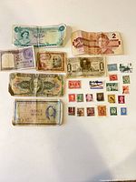 Overview of seven banknotes and multiple stamps