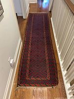 Full length view of wool runner rug on hallway floor
