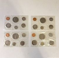 All four sealed mint sets displayed