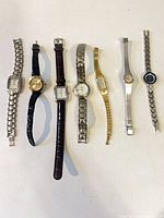 Seven watches laid out side by side for group view