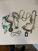 All five necklaces laid out on surface