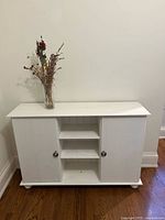 Front view of white wooden cabinet with doors closed