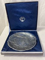 Plate in open presentation box showing Arthur Court 60 logo