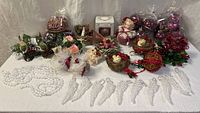Full lot overview on table showing ornaments, garland, angel wings, nests, floral picks