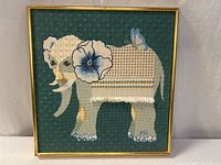 full view of framed needlepoint elephant artwork