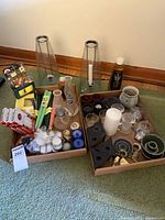 Overall view of two trays with candles, chimney, holders, lamp oil