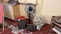 Group view of all items: pedestal fan, floor fan, desk fan, box fan, dehumidifier, extension cord