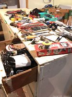 Workbench top with mixed hand tools, socket set, solder and tape