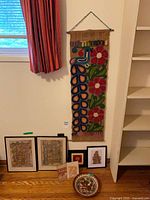 Full lot view showing wall hanging, three framed prints, decorative bowl