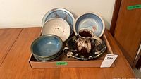 Tray of nine stoneware pieces: three painted plates, four blue-green bowls, brown pitcher on platter