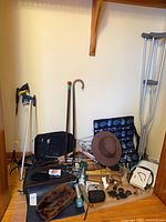 Overview of lot with mobility aids, hats, camera, accessories