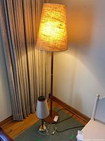 Floor and table lamps side by side, floor lamp lit