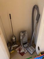 Both vacuums, hose, wand, powerhead and vacuum bag packs in closet