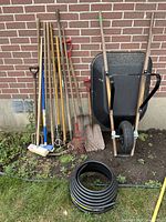 Group shot showing wheelbarrow, all long-handled tools, and edging coil
