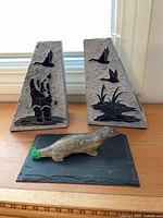 Pair of stone bookends and stone animal figurine on slate base