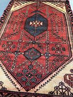 Full view of handmade Persian rug showing complete field and border