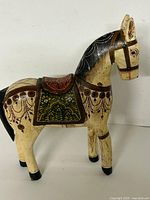 Full left-side view of the carved wooden horse