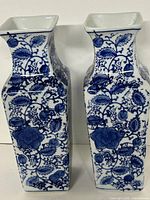 Front view of both blue and white ceramic vases