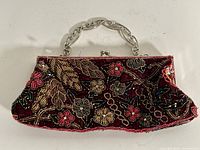 Full view of clutch front showing beadwork and handle