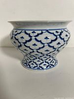 full side view of porcelain vase showing pattern and shape