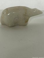 Left side view of carved stone polar bear