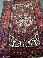 Full view of Persian red and ivory geometric rug