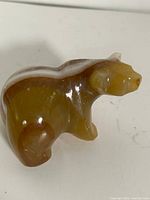 Left-rear view of polished onyx bear figurine showing overall shape and coloration