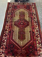 Full view of Persian wool rug showing entire design and borders