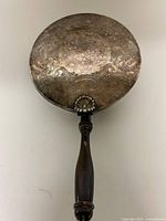 Full view of bed warmer showing handle and ornate lid