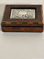 Closed box angled view showing wood grain and sterling silver inlay on lid