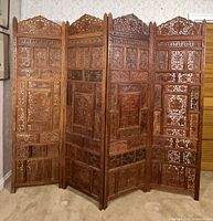 Full view of five-panel carved wood room divider