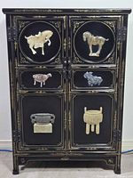 front view of cabinet showing stone animal inlays and two-door configuration