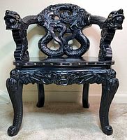 Front view showing full chair, dragon carvings, and armrests
