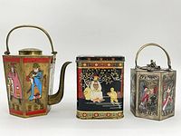 Front view of all three caddies showing shapes, enamel panels and handles