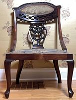 Full side view of mahogany Rococo Revival chair