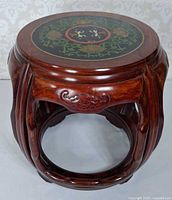 Top view showing enamel floral medallion and wood finish