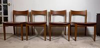 Front view of all four wooden chairs in a row
