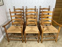 Front view showing all six ladder-back chairs