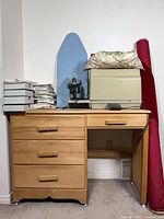 Entire lot showing desk, ironing board, fabric bolt, boxes and attachments