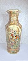 Front view of tall hexagonal porcelain vase with famille-rose decoration