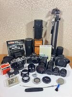 Overall view of two Pentax cameras, five additional lenses, tripod, cases, accessories and manuals