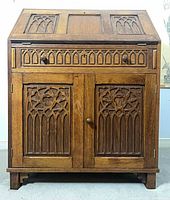 Front view closed showing carved drawer and cabinet doors