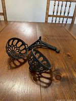 String holder cage and wall bracket on wooden table