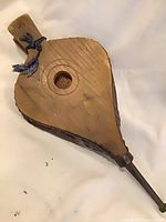 Overall view of wooden paddle side with rope loop