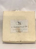 Cream presentation box top with maker label