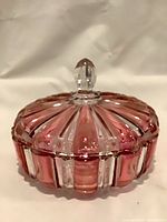 Covered dish assembled showing cranberry and clear striped ribs and knob finial